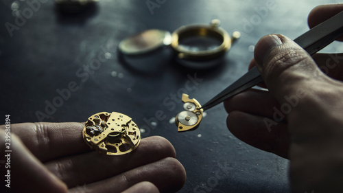 Watch maker is repairing a vintage automatic watch. photo