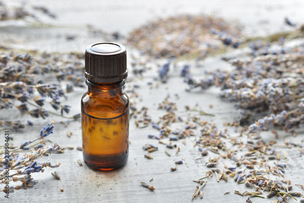 lavender essential oil with lavender on wooden background lavender essential oil with lavender on wooden background