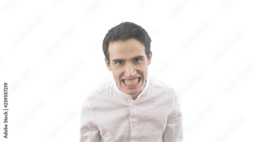 Portrait of young angry man isolated on white background. Negative human emotions Portrait of young angry man isolated on white background. Negative human emotions