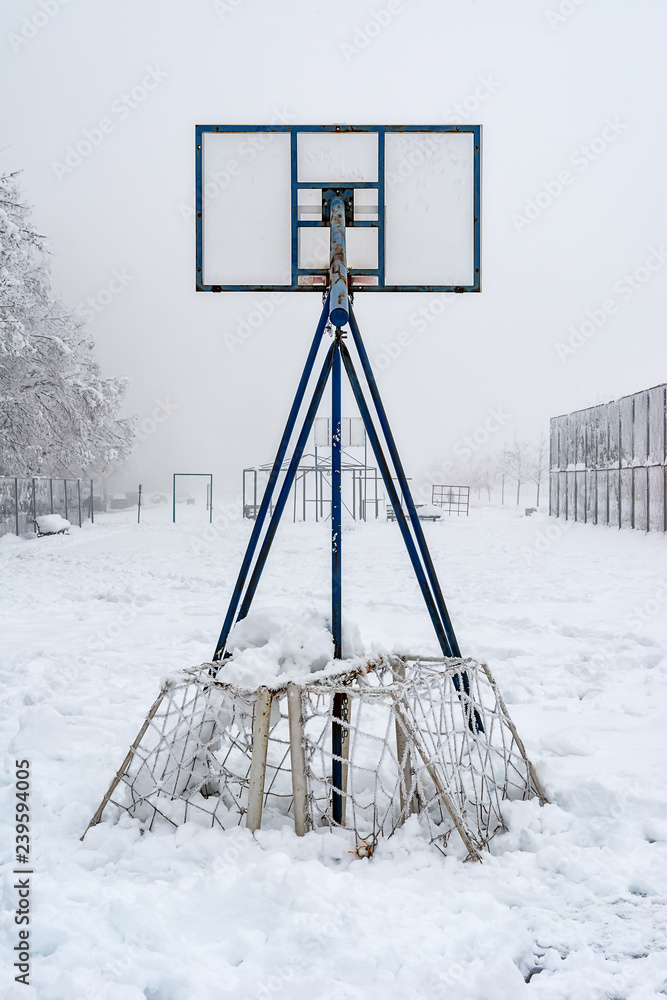 Fototapeta premium Basketball court covered with snow