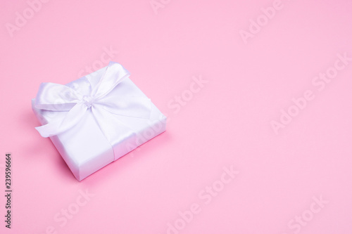 White gift box on pink.