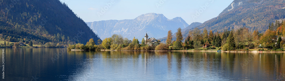 Grundlsee Castle on the sunny autumn day, located on the shore of lake Grundlsee. Grundlsee, Styria, Austria.