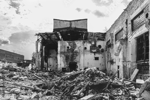 Earthquake or war aftermath or hurricane or other natural disaster, broken ruined abandoned industrial buildings, pills of concrete garbage
