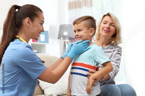 Children s doctor visiting little boy at home