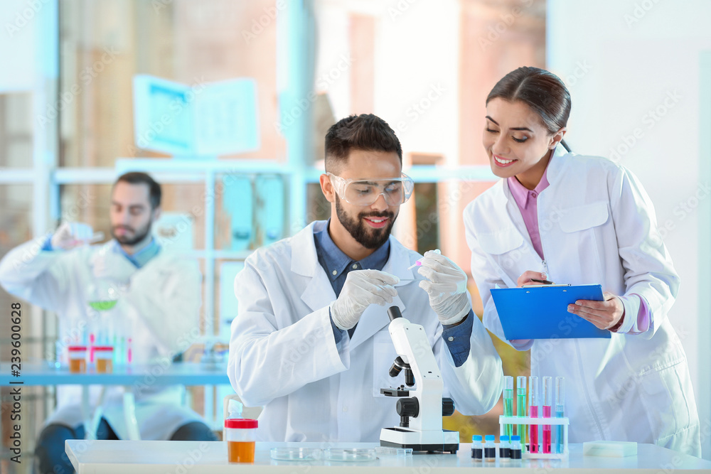 Young scientists working in laboratory. Chemical analysis Young scientists working in laboratory. Chemical analysis