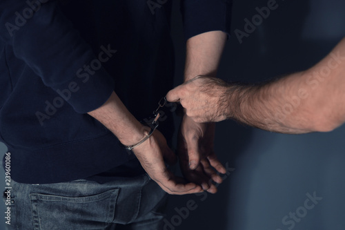 Man putting handcuffs on drug dealer  closeup view