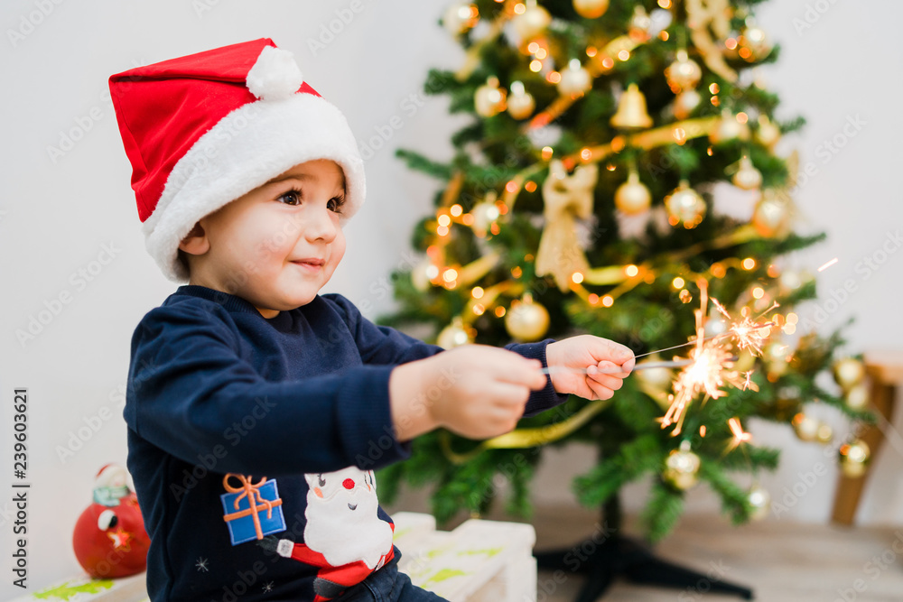little boy in santa hat with sparklers little boy in santa hat with sparklers