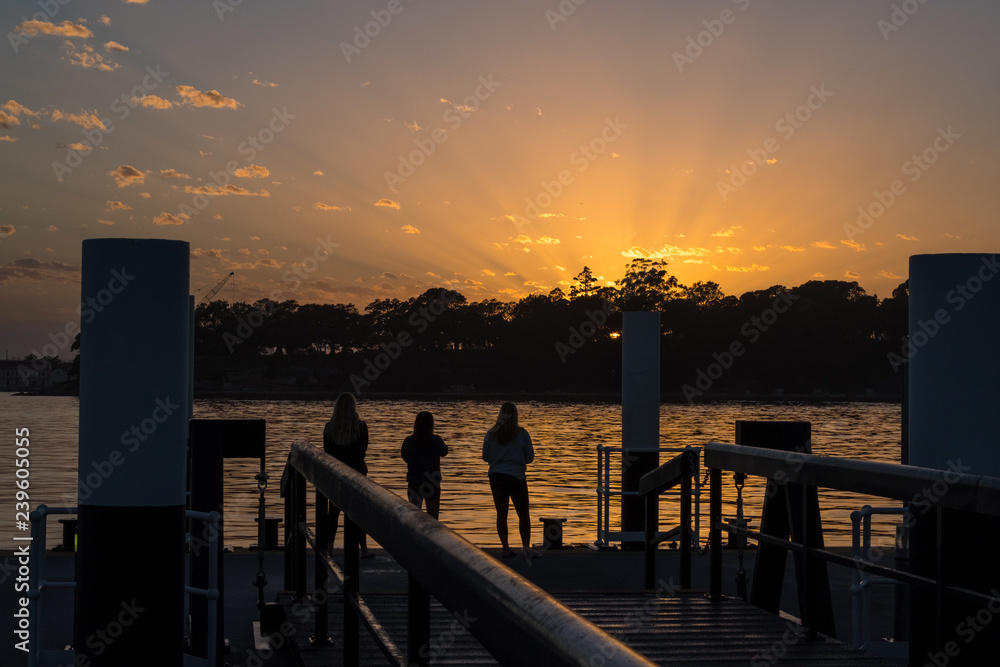 Young tourists watching the sunrise on Sydney Harbour