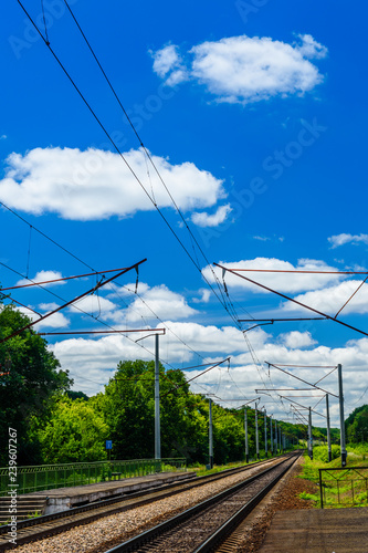 View on a railroad track and white clouds in blue sky