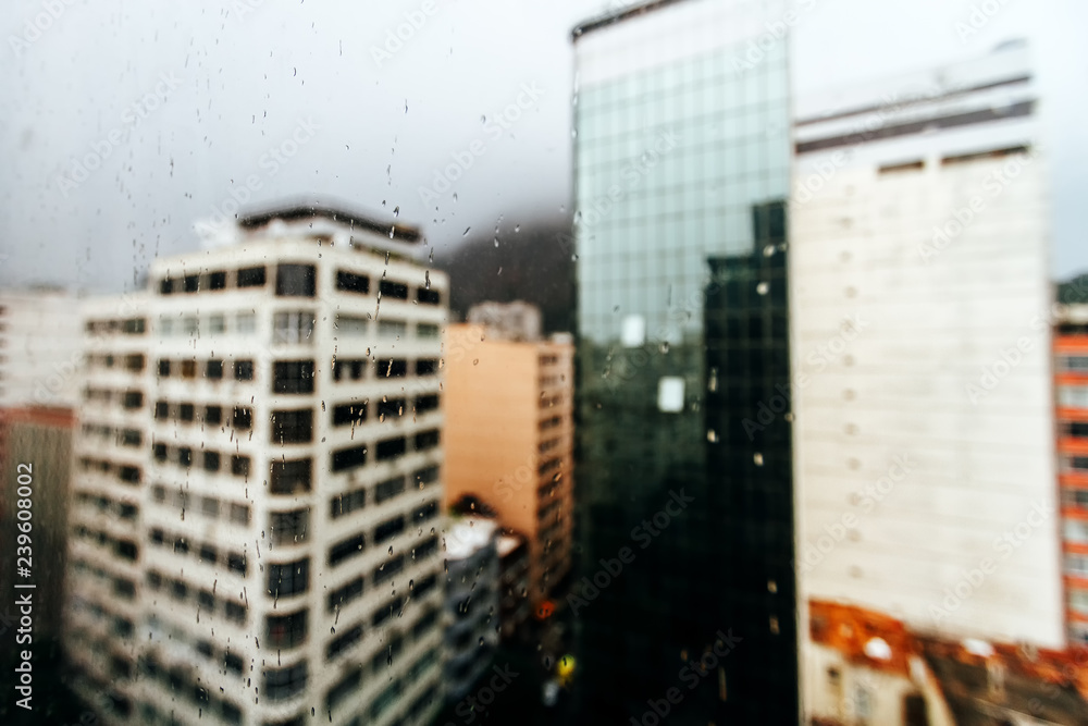 Macro of rain drops on a window with buildings in the background in the Copacabana neighborhood (Rio de Janeiro)