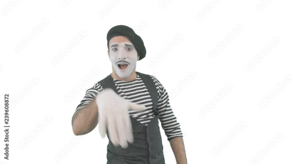Happy mime showing thumbs up. Cheerful behavior and broad smile of a male actor during the pantomime show. Isolated on white background. Happy mime showing thumbs up. Cheerful behavior and broad smile of a male actor during the pantomime show. Isolated on white background.