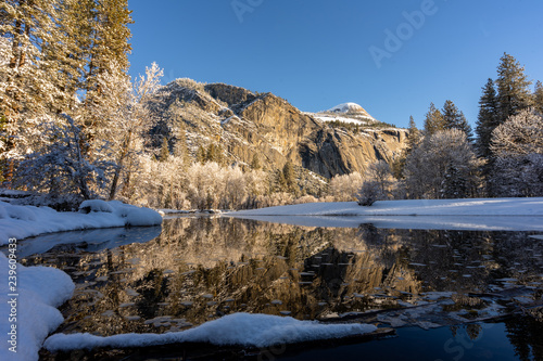 mountain trees and river with snow and shadows