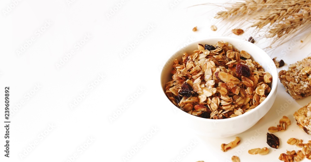 Homemade Granola in a bowl on white background, selective focus Homemade Granola in a bowl on white background, selective focus