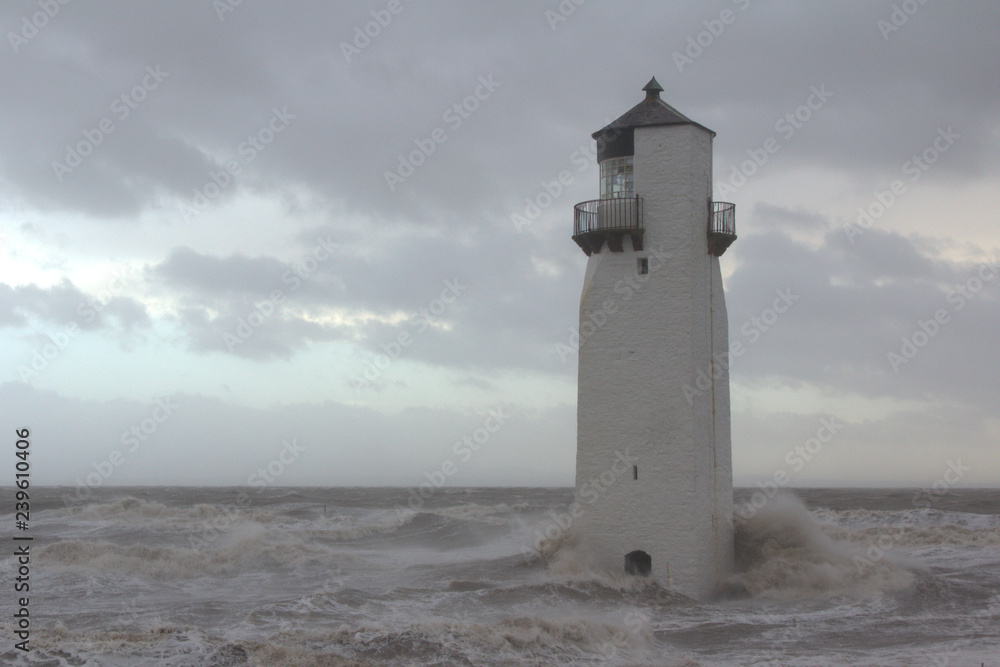 Southerness Lighthouse being battered by a heavy storm. Dumfriesshire, Scotland.