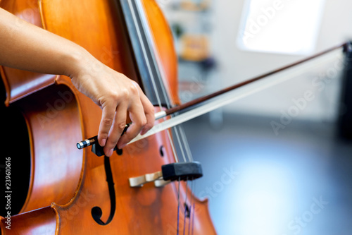 Close up of cello with bow in hands