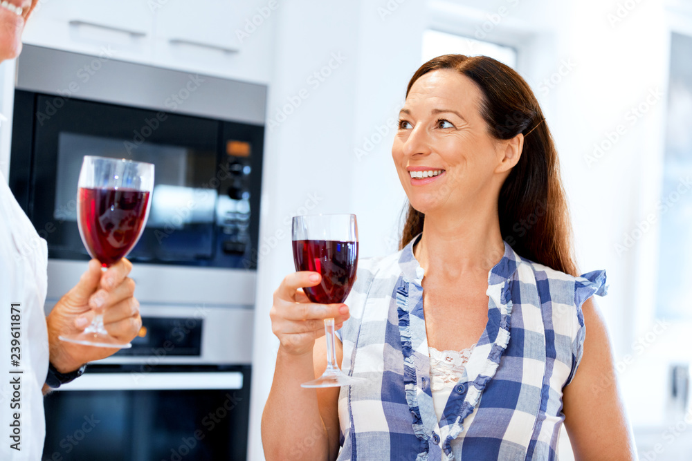 Senior woman with holding a glass of wine indoors Senior woman with holding a glass of wine indoors