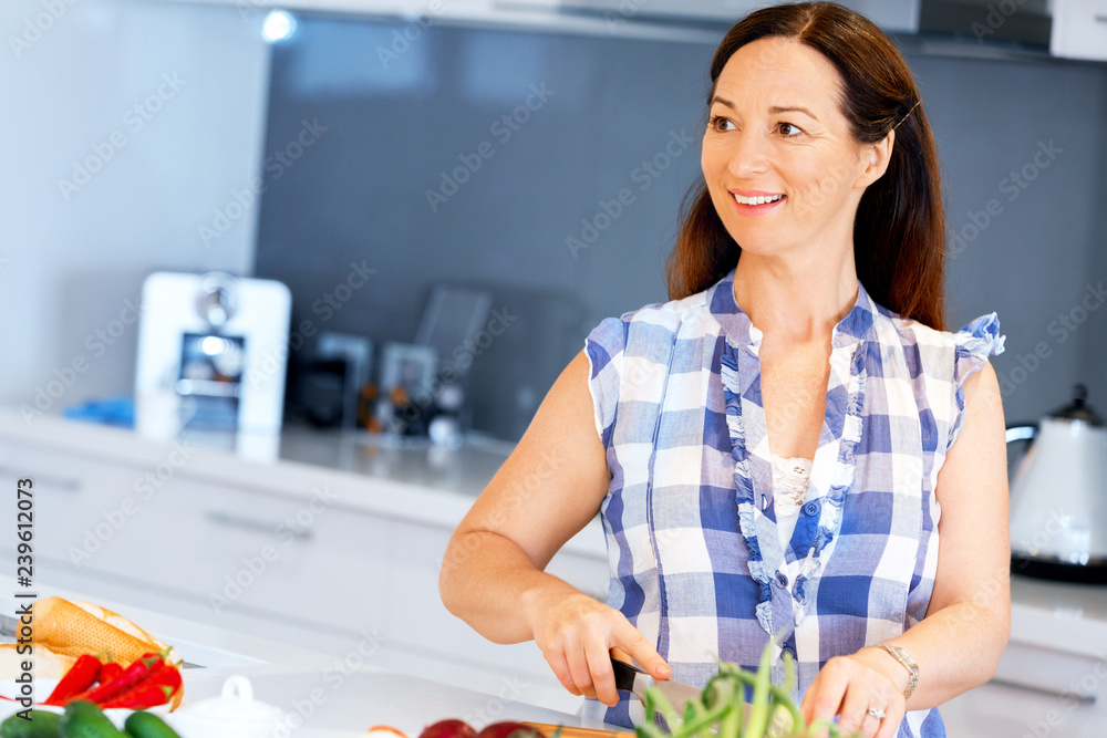 Beautiful woman standing in the kitchen Beautiful woman standing in the kitchen
