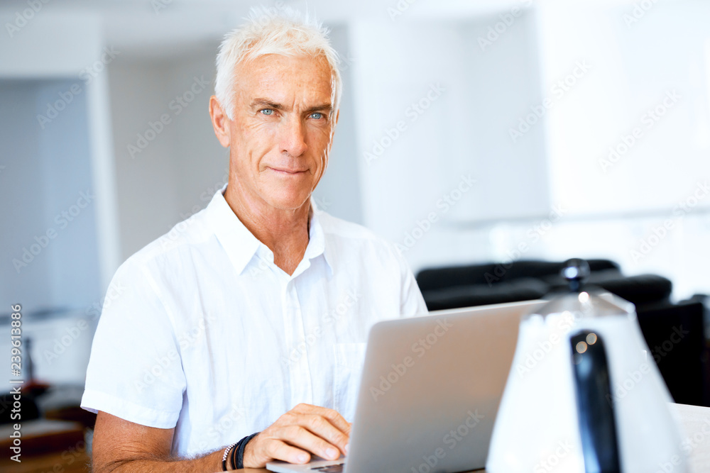 Man working on laptop at home Man working on laptop at home