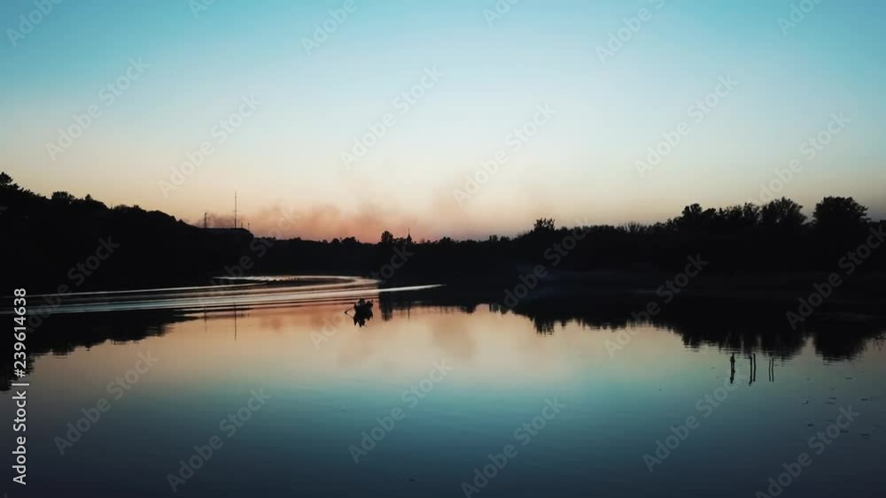 A gondolier is floating on a quiet river at sunset on a warm summer evening. Wonderful view. Slow motion. Camera motion to forward A gondolier is floating on a quiet river at sunset on a warm summer evening. Wonderful view. Slow motion. Camera motion to forward