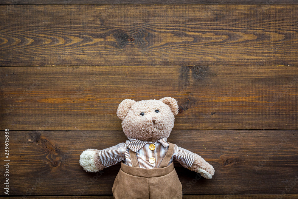 Obraz premium Baby care with craft toys for newborn. Teddy bear. Wooden background top view copy space