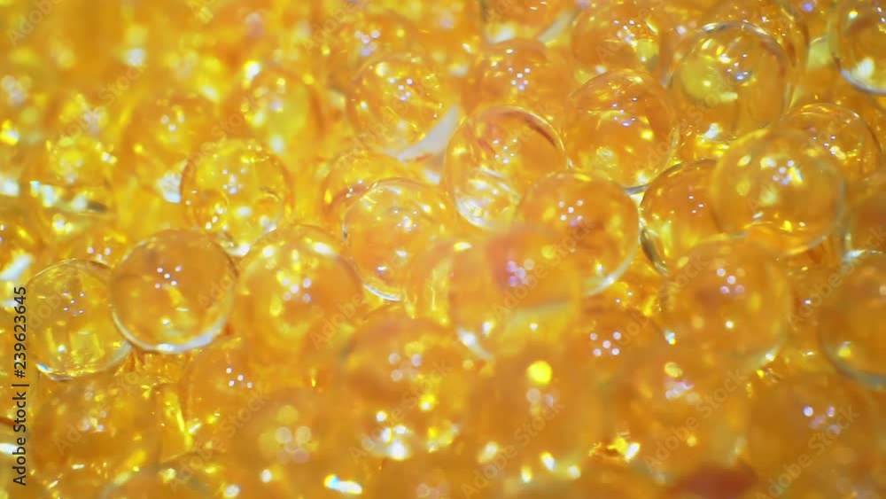 soft gelatin capsules close-up.fish oil capsules.Pharmaceutical production. moving background.shallow depth of field.macro shooting. soft gelatin capsules close-up.fish oil capsules.Pharmaceutical production. moving background.shallow depth of field.macro shooting.