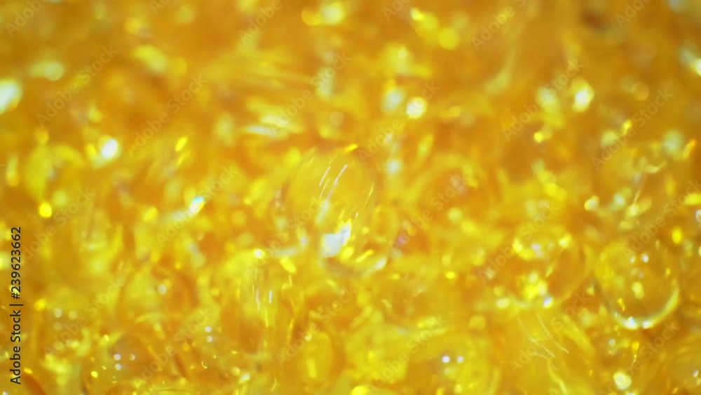 soft gelatin capsules close-up.fish oil capsules.Pharmaceutical production. moving background.shallow depth of field.macro shooting. soft gelatin capsules close-up.fish oil capsules.Pharmaceutical production. moving background.shallow depth of field.macro shooting.