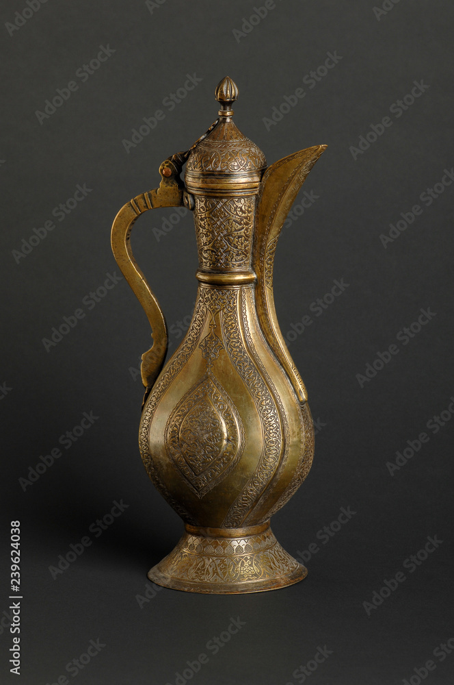 ancient oriental metal teapot on dark background. antique bronze tableware ancient oriental metal teapot on dark background. antique bronze tableware