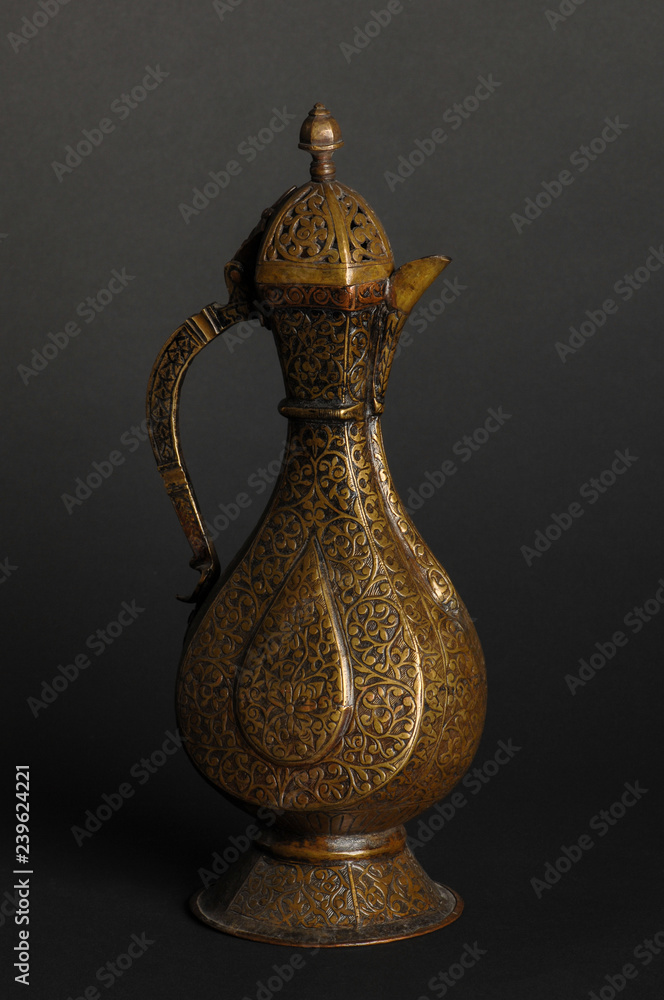 ancient oriental metal teapot on dark background. antique bronze tableware ancient oriental metal teapot on dark background. antique bronze tableware