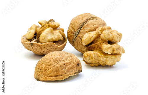 Walnuts, whole and opened on white background