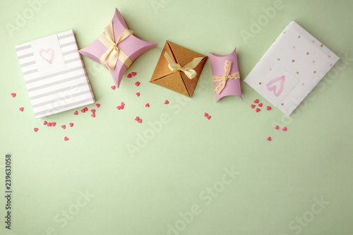 Gift boxes with ribbon on green pastel background with copy space. Minimal cincept of holiday. Top view, spring background