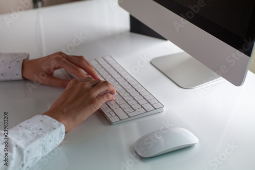 hands of a girl typing on a keyboard with a Russian layout