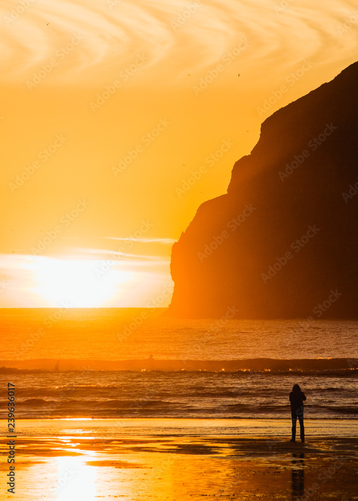 sunset on the beach with silhouette of man