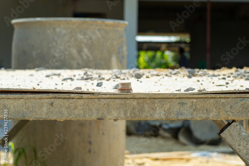 Selective focus on the pile of coins put on the building material. Housing loan concept.