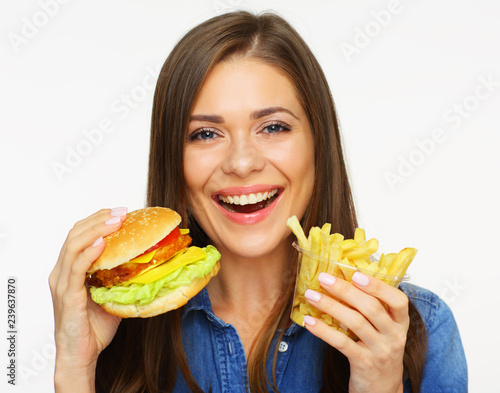 Woman eating fast food  burger with french fries.