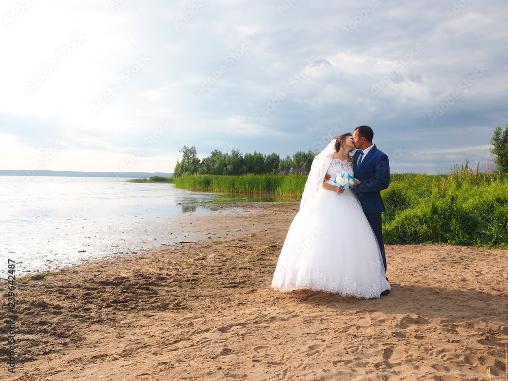 Wedding, the couple kissing. Summer on the beach Wedding, the couple kissing. Summer on the beach