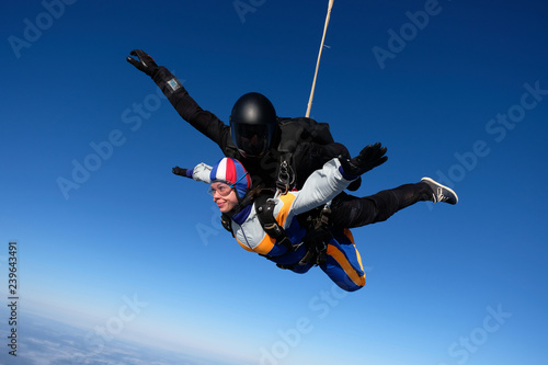 Tandem skydiving in the blue sky.