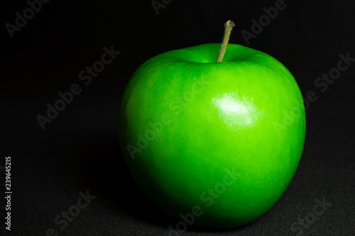 Fresh green apple on black background.