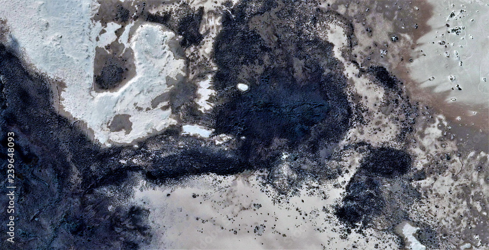 sunspots on the skin of the Earth, black gold, polluted desert sand 