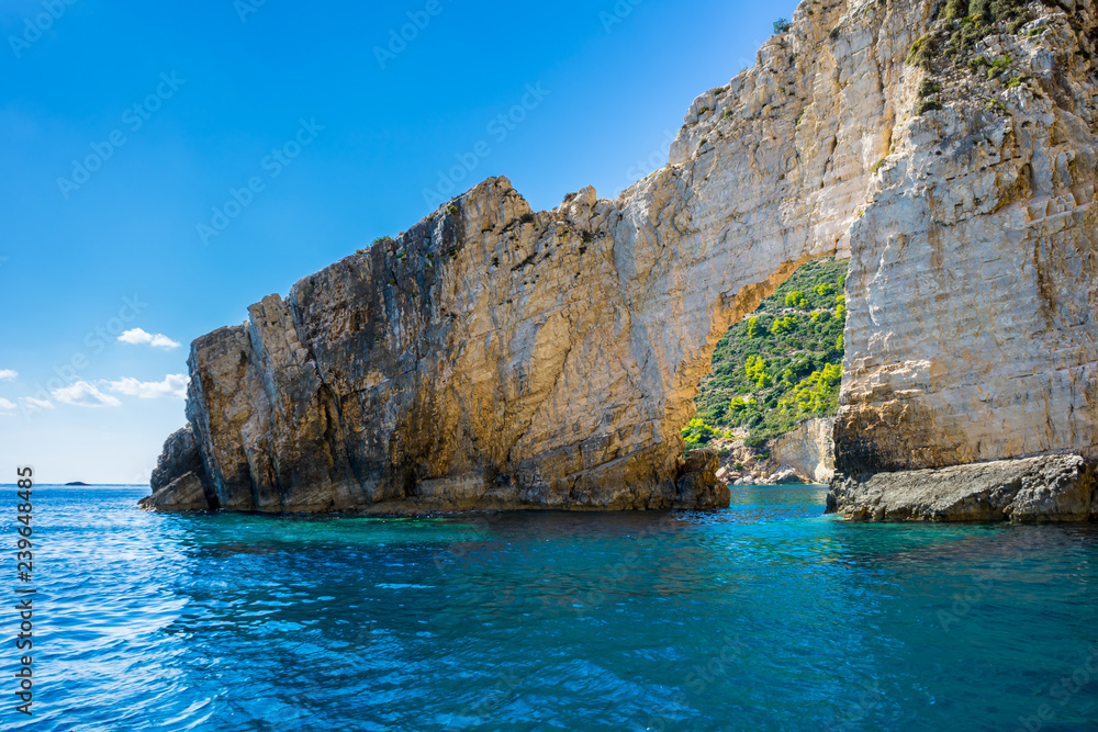 Greece, Zakynthos, Turquoise paradise like ocean water under arch of rock near keri