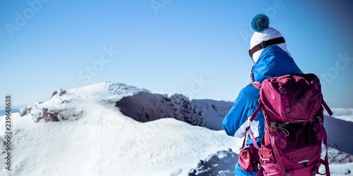 Young woman on mountain top, Woman walking on snowy European mountains, Panoramic view of female in winter sports outfit in mountains