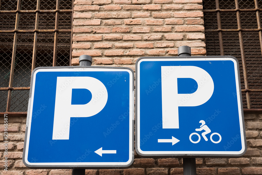 Image of a street sign is seen in this picture. The sign showcases two symbols, one for physcially challenged and the other for cyclists. The signboard is blue in color. Image of a street sign is seen in this picture. The sign showcases two symbols, one for physcially challenged and the other for cyclists. The signboard is blue in color.