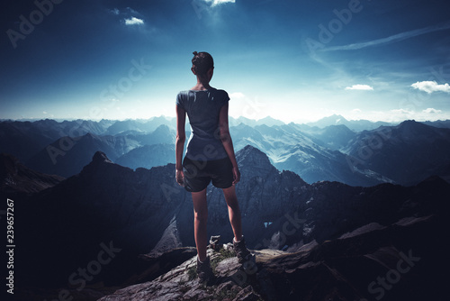 Young sportive woman on top of mountain photo