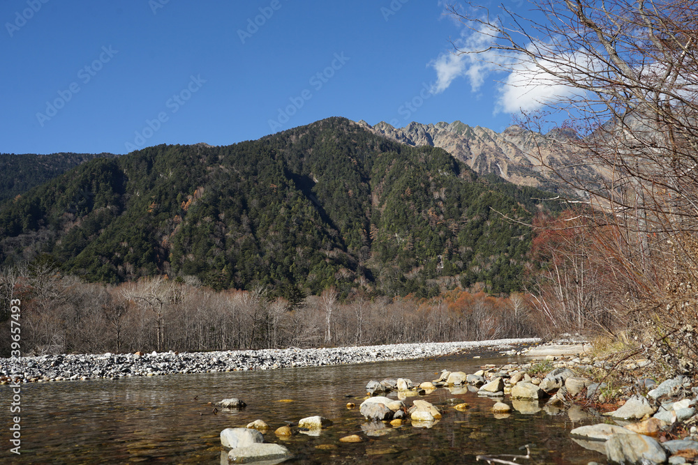 Beautiful crystal clear water river landscape with mountain background in Japan Alps Kamikochi