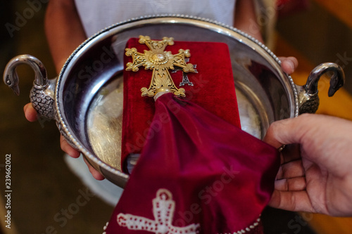 The priest performs the rite at the time of the baptism of the newborn