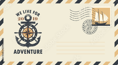 Postal envelope with postage stamp and postmark in retro style. Illustration on the theme of travel with ships wheel and anchor and the words We live for adventure. photo