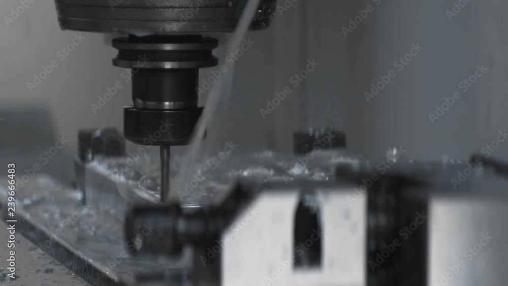 Cnc metal working machine with cutter tool luminium detail milling at factory. Tech process of metalwork and machine manufacturing of press form close up. Precision milling work. Cnc metal working machine with cutter tool luminium detail milling at factory. Tech process of metalwork and machine manufacturing of press form close up. Precision milling work.