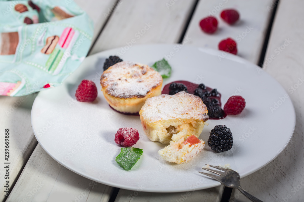 Cottage cheese pancakes, syrniki, curd fritters with fresh berries on white wooden background