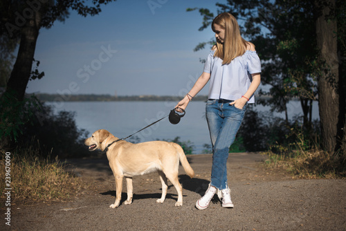 Girl playing with dog labrador outdoor