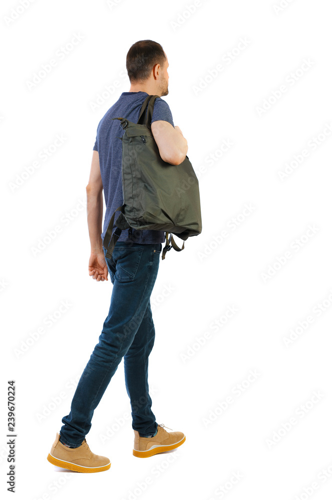 back view of walking man with green bag. back view of walking man with green bag.