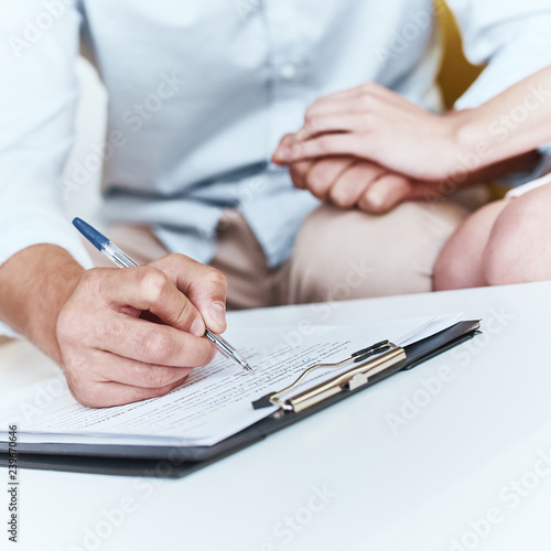 Young lovely couple are signing contract for a vacation. Close-up